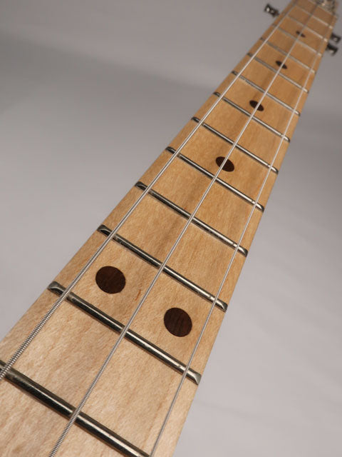 Front tilted view of a 3 string cigar box guitar neck made with maple and walnut. This cigar box guitar is handmade by Mike Snowden of Snowden Guitars.