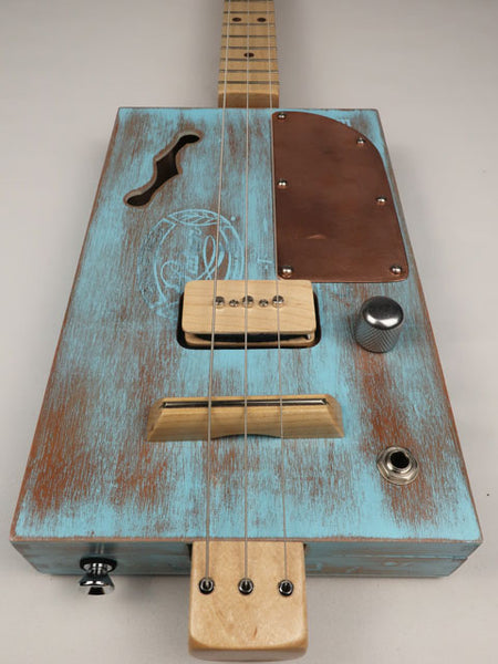 Cigar box guitar blue with p90 pickup made by mike snowden front view.