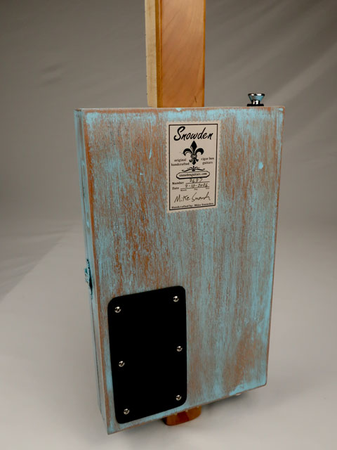 Back view of a blue cigar box guitar with Snowden Guitars logo made by Mike Snowden.