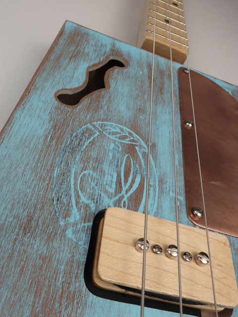 Close-up Padron cigar box guitar p90 pickup made by Mike Snowden.