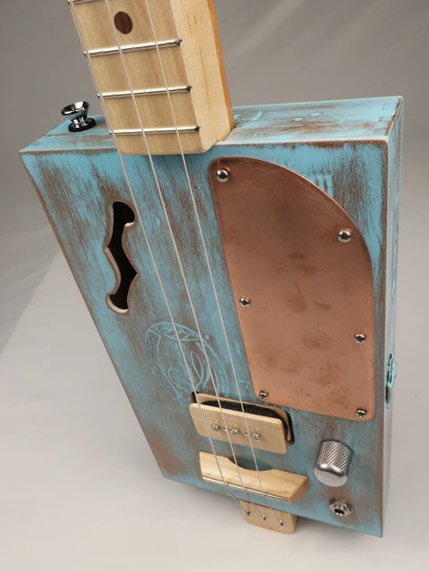 Front angle cigar box guitar with a copper pick guard made by Mike Snowden.