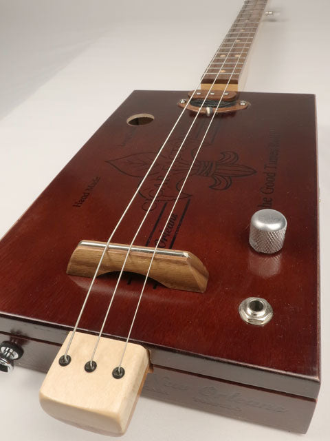 Front tilted view cigar box guitar 3 string new cigar factory with single coil pickup. Handmade by Mike Snowden.