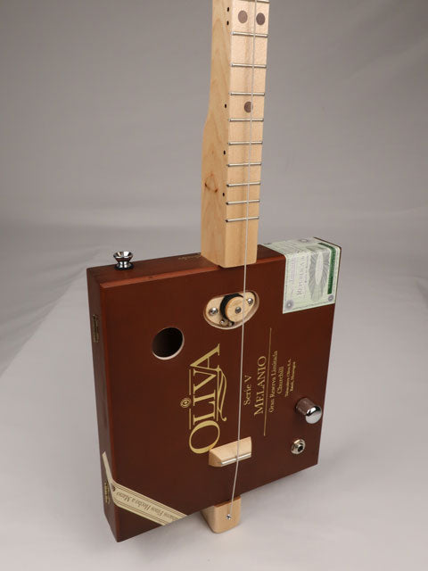 Front view of a one string cigar box guitar diddly bow cbg made with an Oliva cigar box. This cigar box guitar is handmade by Mike Snowden of Snowden Guitars.