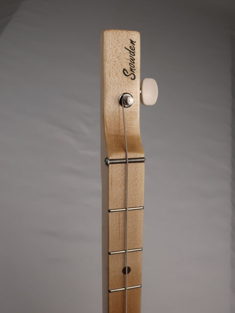 Front view of a cigar box guitar headstock with a Snowden Guitars logo on the front.