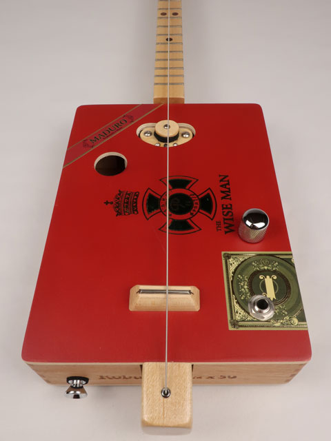 Front view of a one String cigar box guitar diddly bow cbg handmade by Mike Snowden of Snowden Guitars. This cigar box guitar is made with a wise man cigar box.