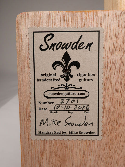 Back view of a cigar box guitar with a Snowden Guitars logo on the back. 