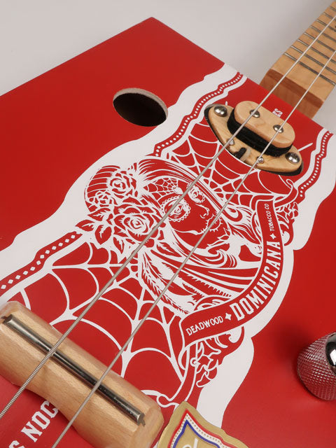 Close up front tilted view of a 2 string cigar box guitar made with a Deadwood Dominicana cigar box. Handmade by Mike Snowden of Snowden Guitars in Marietta GA USA.