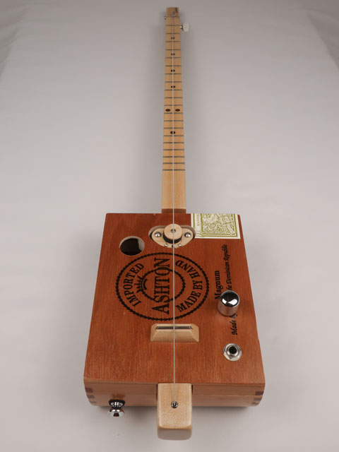 Front view of a Cigar Box Guitar diddly bow one string handmade by Mike Snowden. This cigar box guitar is made with an Ashton cigar box by Mike Snowden of Snowden Guitars.