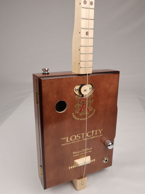 Front tilted view of a one String diddly bow cigar box guitar CBG handmade by Mike Snowden of Snowden Guitars. This cigar box guitar is handmade with a Lost City cigar box.