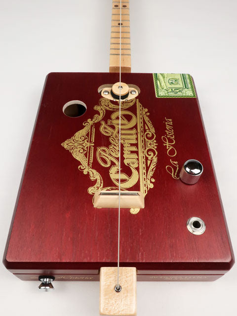 Front view of a one string diddly bow CBG cigar box guitar made with a Perez Carrillo cigar box handmade by Mike Snowden of Snowden Guitars. 