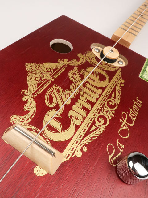 Tilted view of a one string diddly bow CBG cigar box guitar made with a Perez Carrillo cigar box handmade by Mike Snowden of Snowden Guitars. 