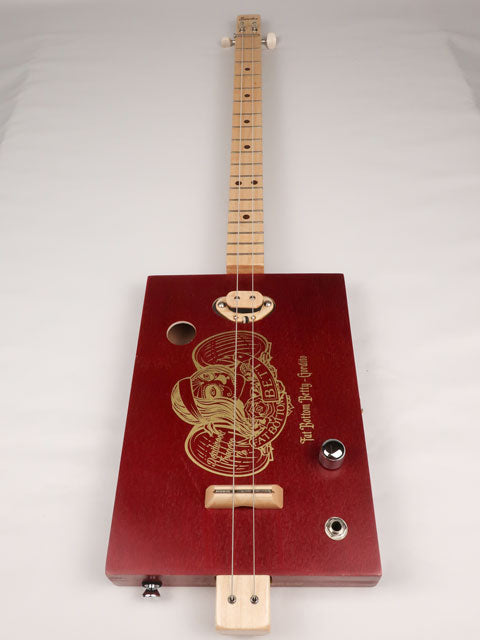 Front view of a cigar box guitar made with a Fat Betty cigar box This cigar box guitar is handmade by Mike Snowden of Snowden Guitars.