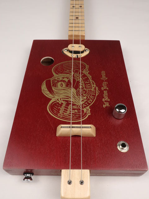 Front view of a cigar box guitar made with a Fat Betty cigar box This cigar box guitar is handmade by Mike Snowden of Snowden Guitars.