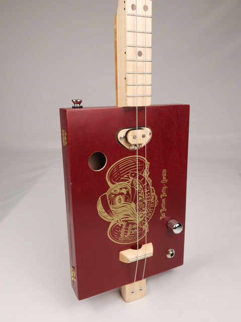 Front view of a cigar box guitar made with a Fat Betty cigar box This cigar box guitar is handmade by Mike Snowden of Snowden Guitars.