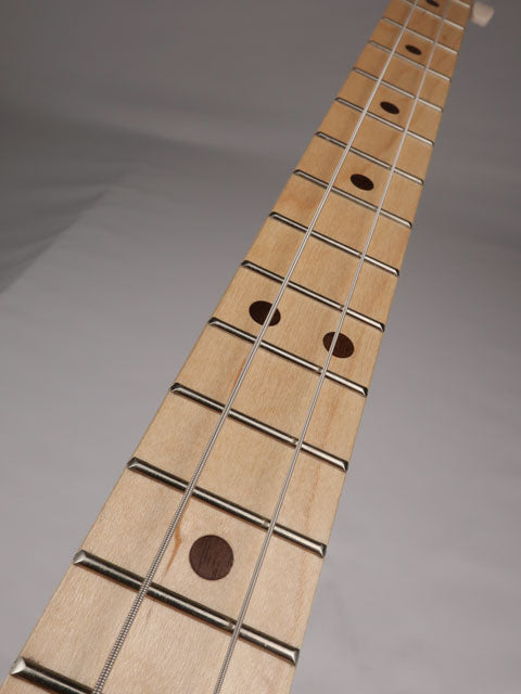Tilted view of a cigar box guitar neck with maple fretboard and walnut inlay handmade by Mike Snowden of Snowden Guitars.