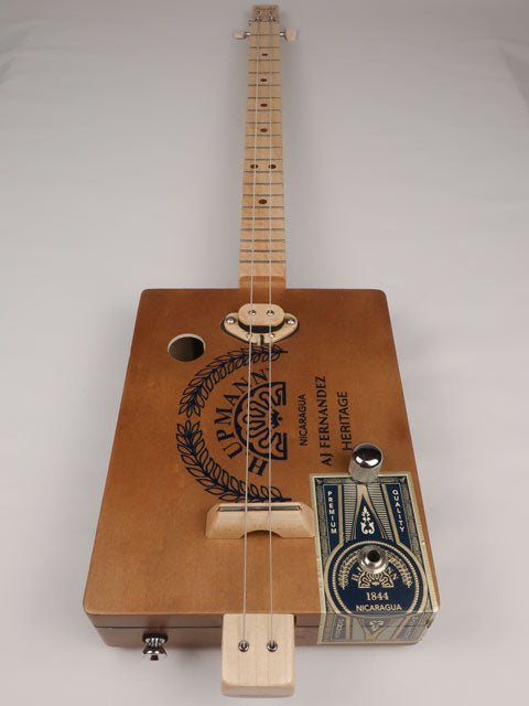 Front view of a 2 string cigar box guitar cbg made with a H. Upmann cigar box. This cigar box guitar was handmade by Mike Snowden of Snowden Guitars.