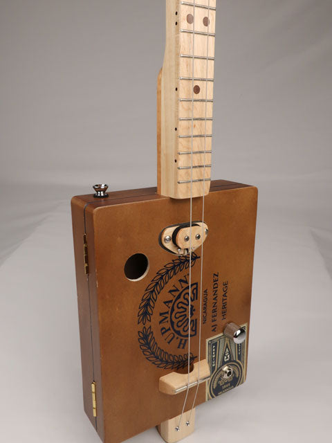 Front view of a 2 string cigar box guitar cbg made with a H. Upmann cigar box. This cigar box guitar was handmade by Mike Snowden of Snowden Guitars.