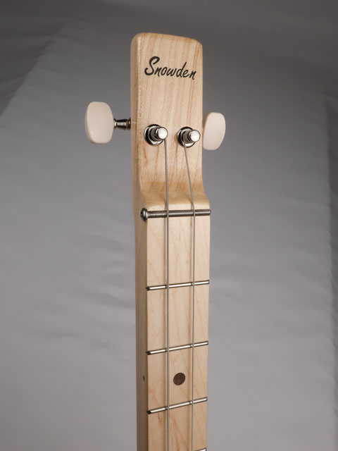 Front view of a cigar box guitar headstock with Snowden Guitars logo on the front.