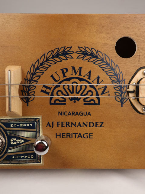 Side view of a 2 string cigar box guitar cbg made with a H. Upmann cigar box. This cigar box guitar was handmade by Mike Snowden of Snowden Guitars.