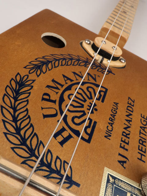 Front view of a 2 string cigar box guitar cbg made with a H. Upmann cigar box. This cigar box guitar was handmade by Mike Snowden of Snowden Guitars.