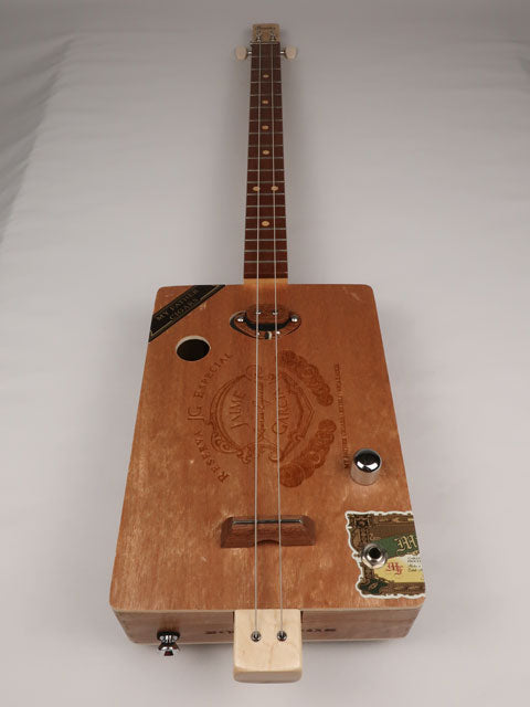Front view of a cigar box guitar with a Jaime Garcia cigar box. This cigar box guitar is handmade by Mike Snowden of Snowden Guitars.