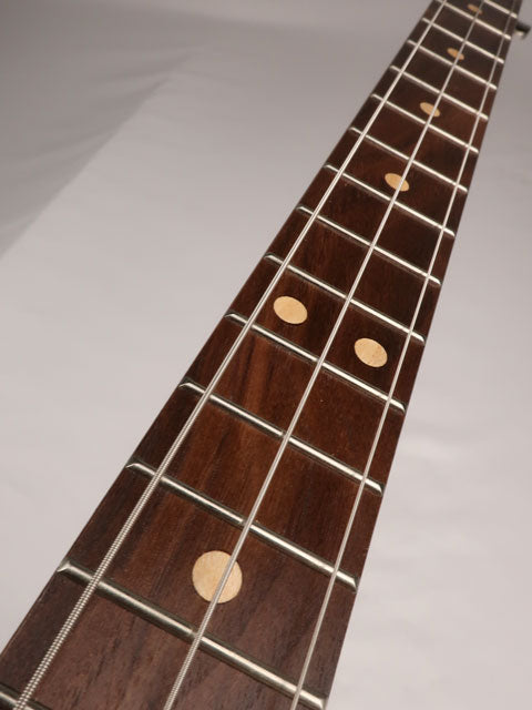 Front view of a 3 string cigar box guitar neck with a walnut fretboard with maple inlay. This cigar box guitar is handmade by Mike Snowden of Snowden Guitars.