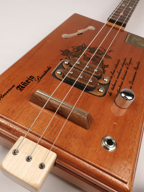 Front view of a 3 string cigar box guitar made with a A Fuente cigar box. This cigar box guitar is made by Mike Snowden of Snowden Guitars. 