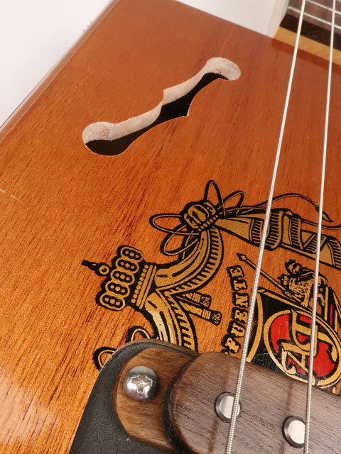 Close up view of a 3 string cigar box guitar made with a A Fuente cigar box. This cigar box guitar is made by Mike Snowden of Snowden Guitars. 