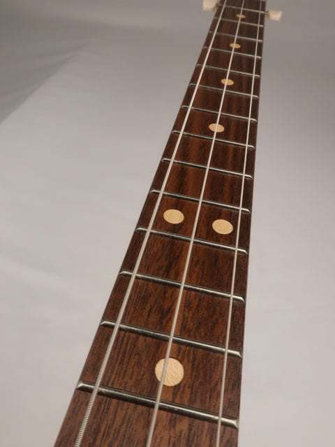Front view of a 3 string cigar box guitar neck made with a walnut fret board and maple inlay.