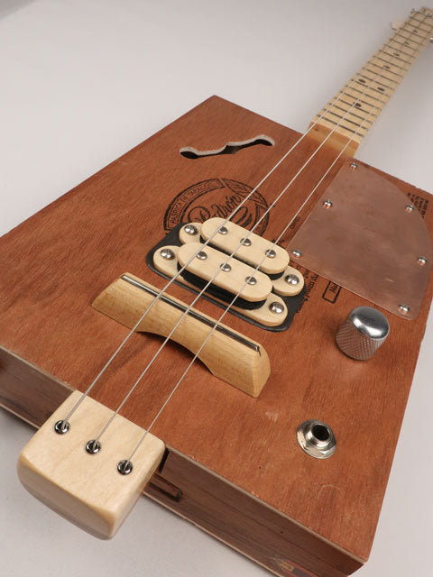 Front tilted view of a 3 string cigar box guitar made with a Padron cigar box. Handmade by Mike Snowden of Snowden Guitars.